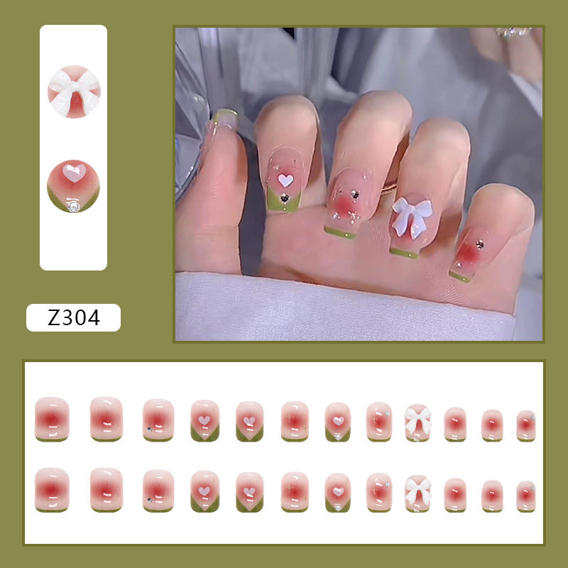 Decorative Nails with Heart and Bow Design, French Tips with Green Border, Rhinestone Accents, Press-On Nails