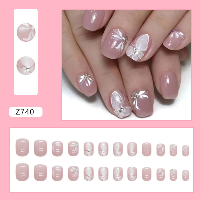 Elegant Butterfly Nail Art Design, Pink Base with White Floral Pattern, Crystal Rhinestone Accents, Press on Nails