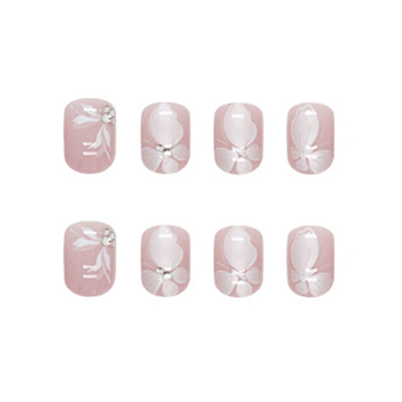 Elegant Butterfly Nail Art Design, Pink Base with White Floral Pattern, Crystal Rhinestone Accents, Press on Nails