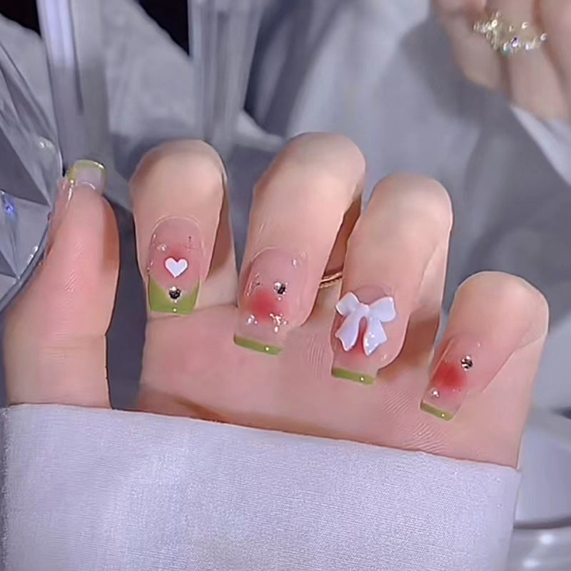 Decorative Nails with Heart and Bow Design, French Tips with Green Border, Rhinestone Accents, Press-On Nails